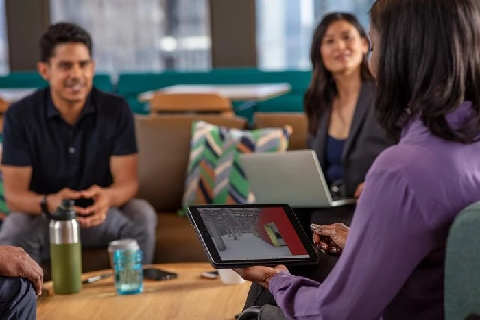 Three people gather for meeting