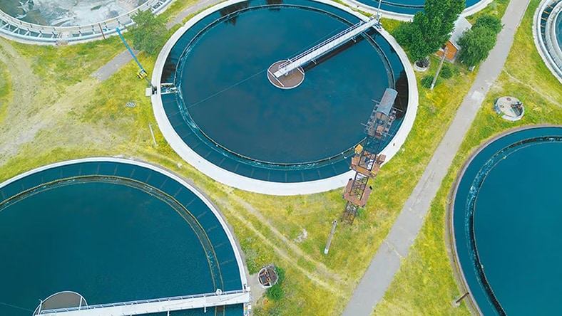An overhead photo shows water tanks at a power station.