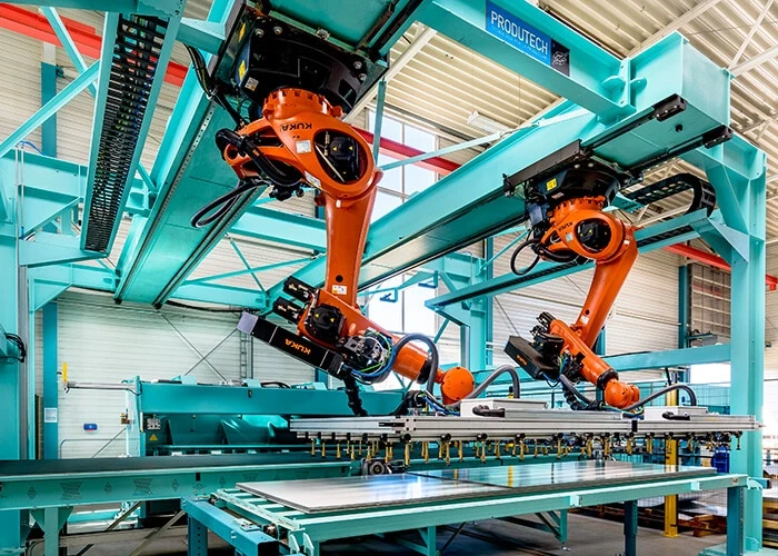 Orange industrial robots in a factory setting