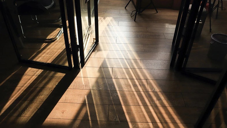 The sun shines on wood flooring