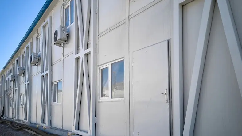 A steel prefabricated building houses a series of office spaces.