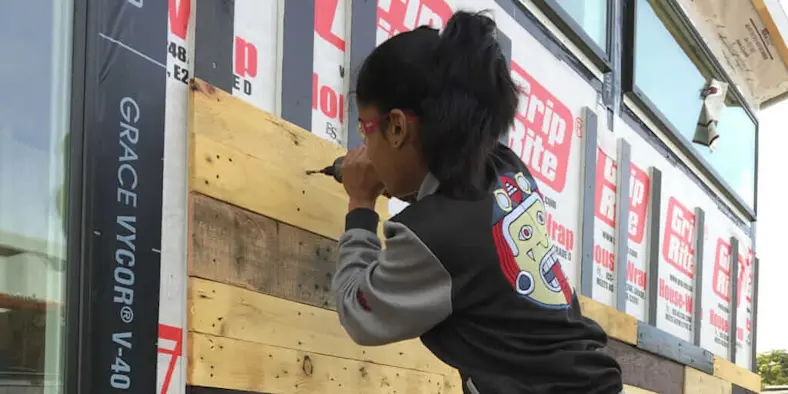 A kid building a building.