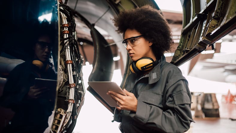 Female aerospace engineer using tablet.