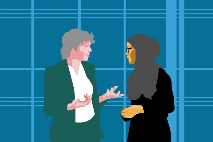 two businesswomen talk face to face