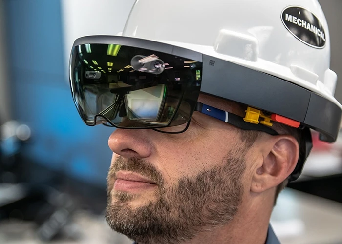 Person uses a smart helmet equipped with AR on a construction site 