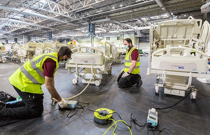Workers set up hospital beds at NHS Nightingale Hospital Birmingham
