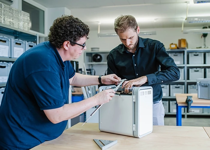 Two people measuring the NelumBox