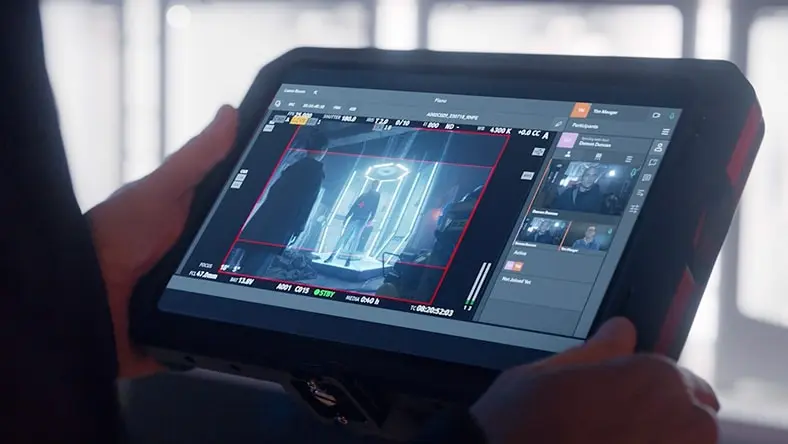 Tablet showing a video production interface with a futuristic scene.
