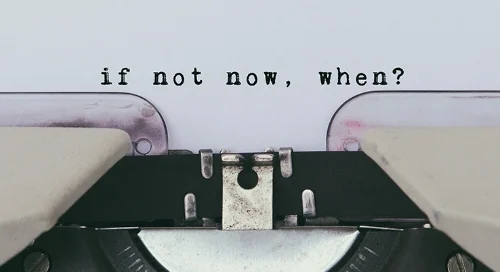 Close-up of a typewritten statement, "if not now, when?"