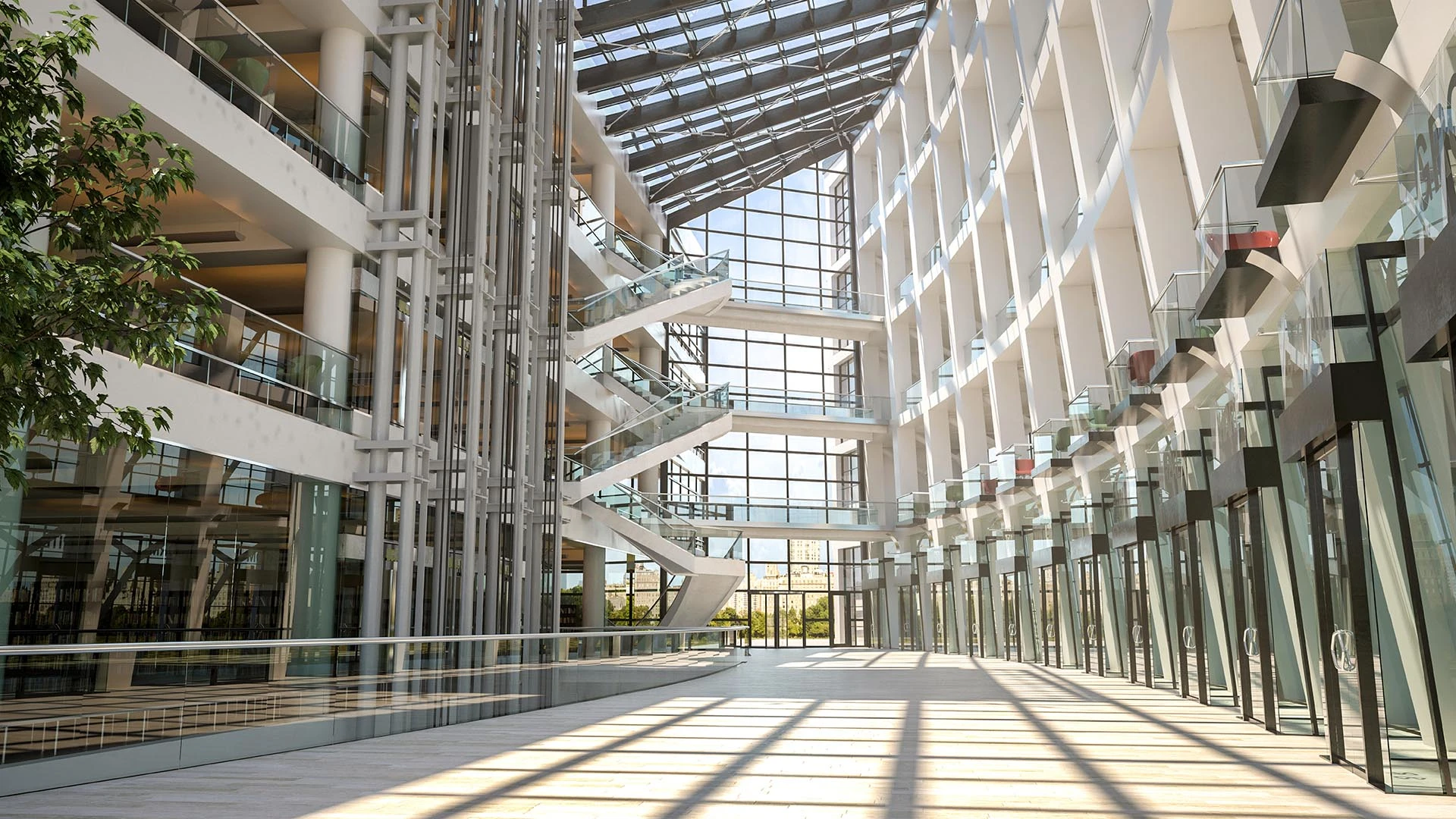 La luz del sol se filtra por una claraboya hacia un amplio atrio moderno, donde paredes acristaladas y escaleras blancas articulan un espacio abierto en varios niveles.