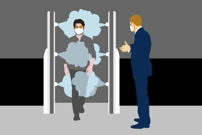 In this illustration, a man enters a disinfecting machine on his way into an office.