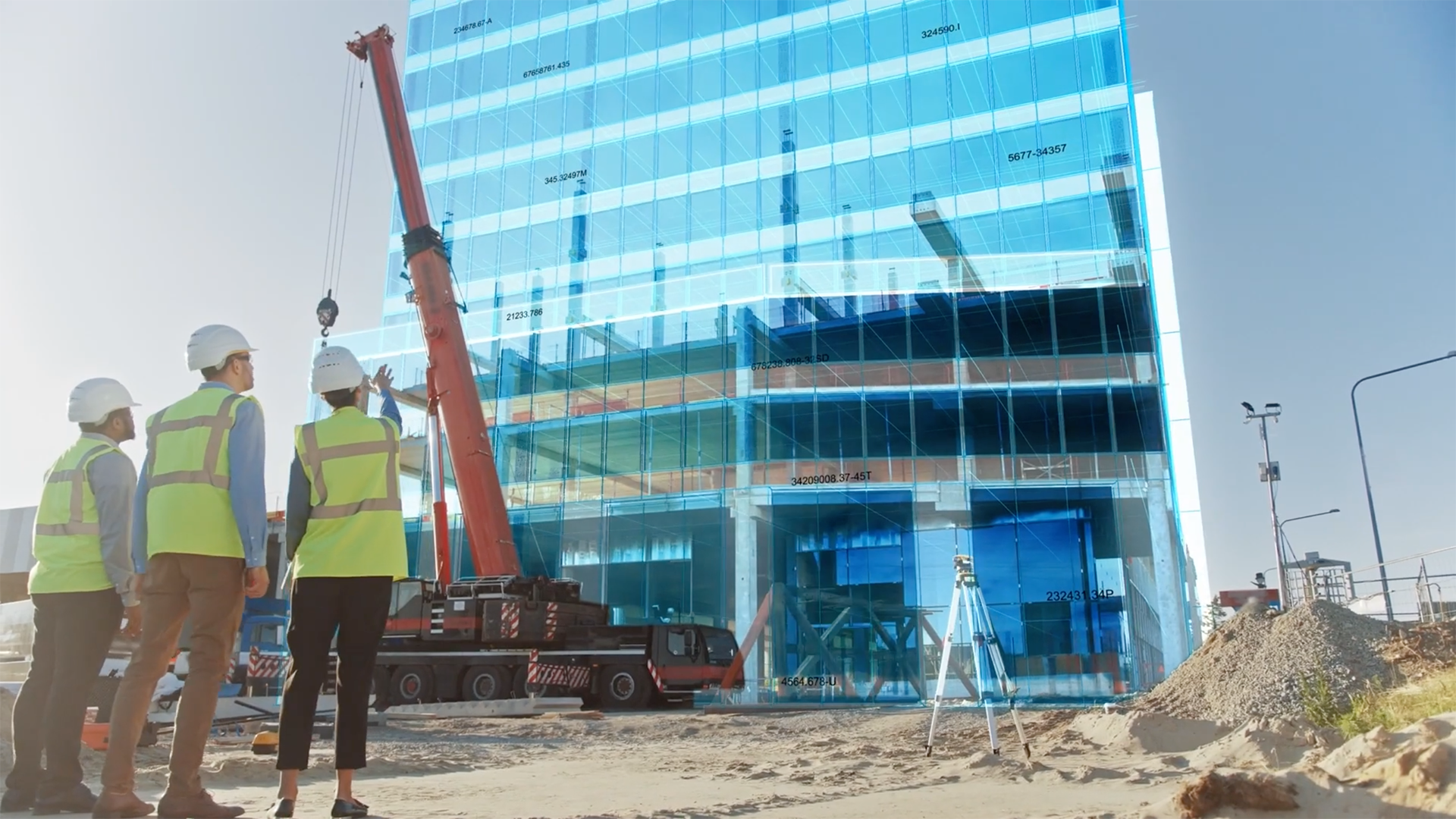 Three men in hard hats look at a building on a construction site overlaid with building model data.