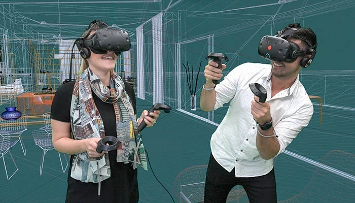 在慕尼黑的欧特克VR卓越中心，人们佩戴VR目镜在3D线框情景中观看虚拟结构。