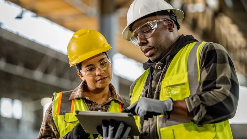 Architecture project management construction managers in safety equipment on site