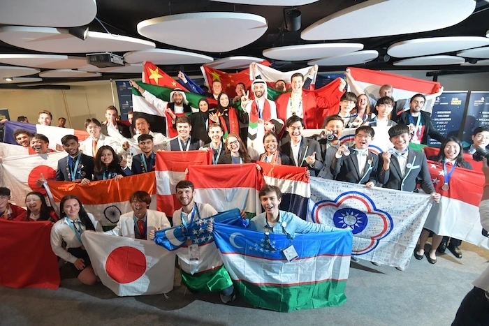 Many people hold flags from various countries.
