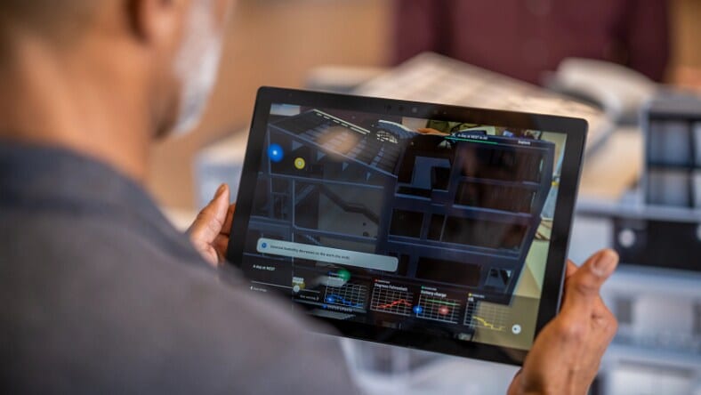 Employee looking at digital twin on a tablet
