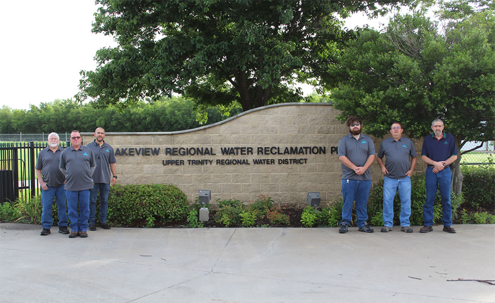 Upper Trinity Water District Employees in front of Sign