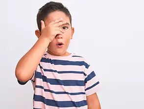 Boy covering his face with his hand
