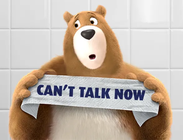 El Oso Leonard sosteniendo el mensaje "No puedo hablar ahora" sobre papel de baño