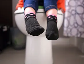 Toddler sitting on toilet for potty training