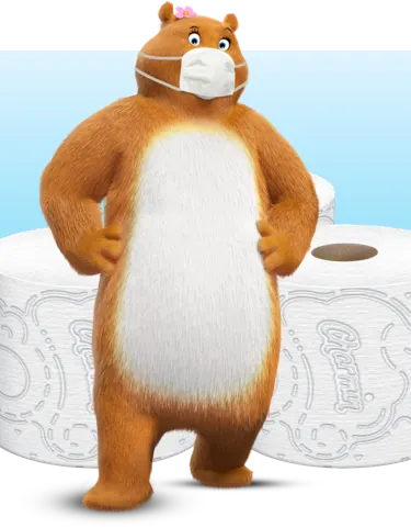 Molly in a mask standing in front of toilet paper rolls