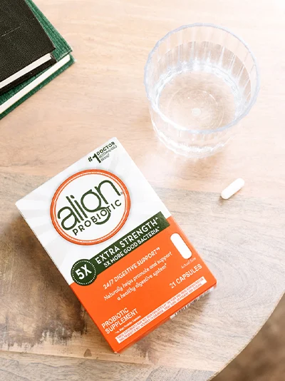 Align Probiotic Extra Strength package, pill and a glass of water.