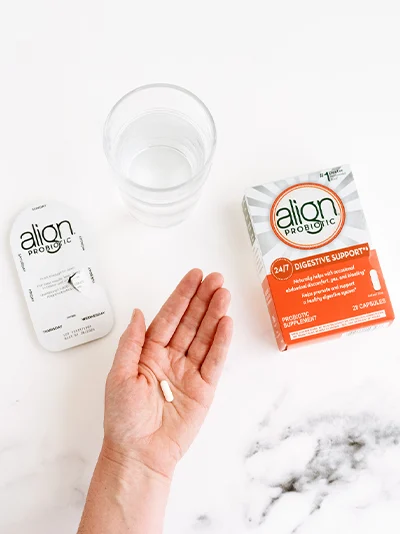 Align Probiotic 24/7 Digestive Support package, a pill and a glass of water.