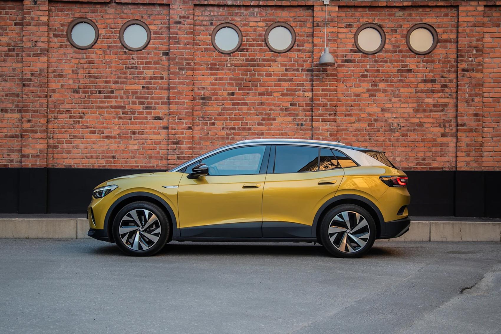 Guldfärgad bil framför tegelvägg