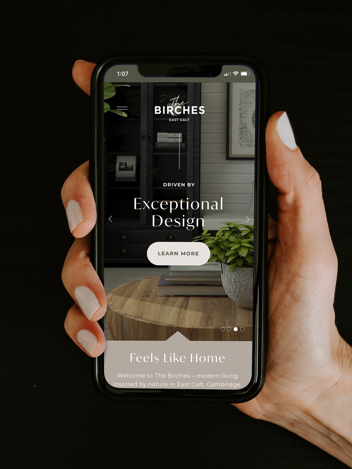 Website viewed on mobile phone with hero text "Exceptional Design"