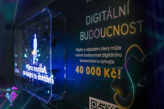 A digital sign in Czech displays the text Digitální budoucnost and promotes a competition to influence digital banking with a prize of 40,000 Kč. Neon graphics and a futuristic design are visible.