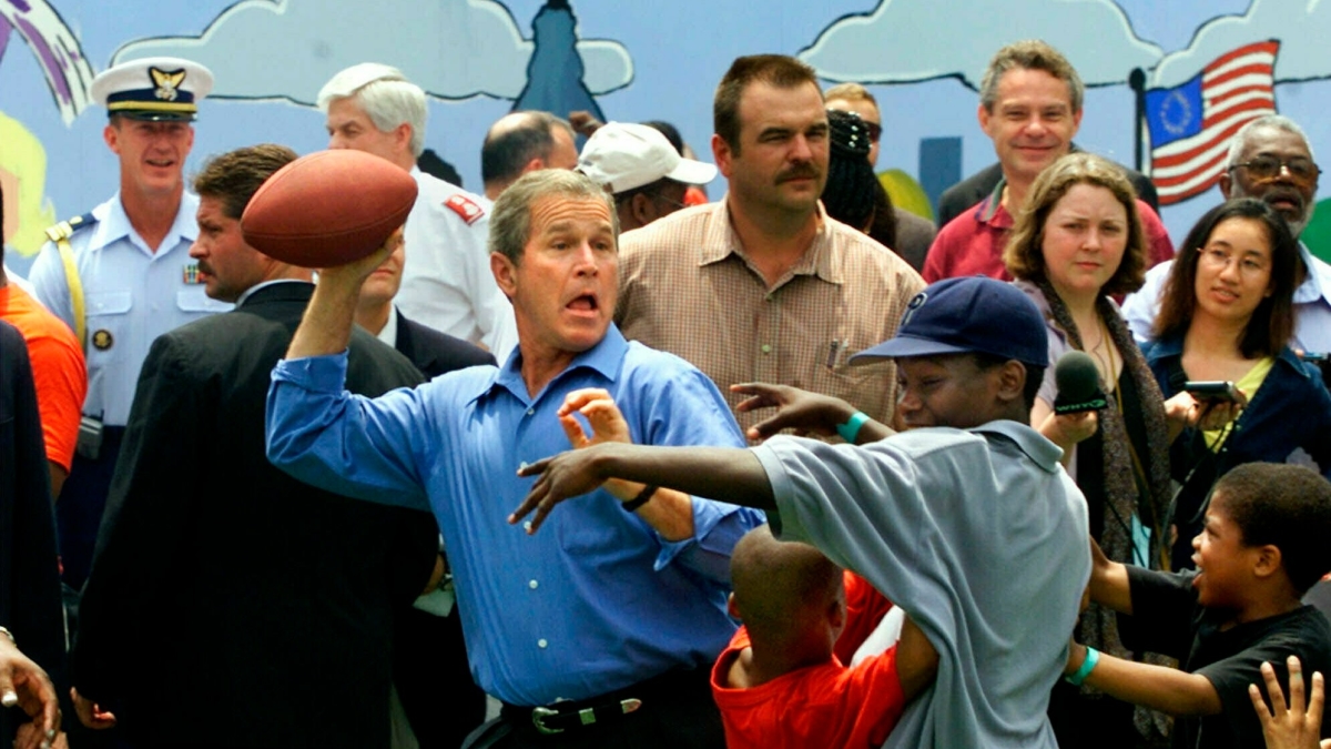 President George W. Bush celebrates the Fourth of July holiday in 2001 in Philadelphia by playing street football with kids at a church-sponsored block party that promoted his faith-based initiative. 