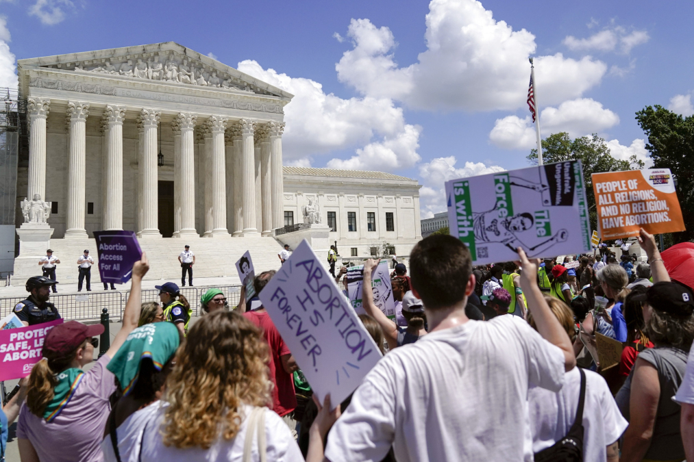 Demonstrators hold signs as they rally outside the Supreme Court building during the Women's March in Washington, Saturday, June 24, 2023. 