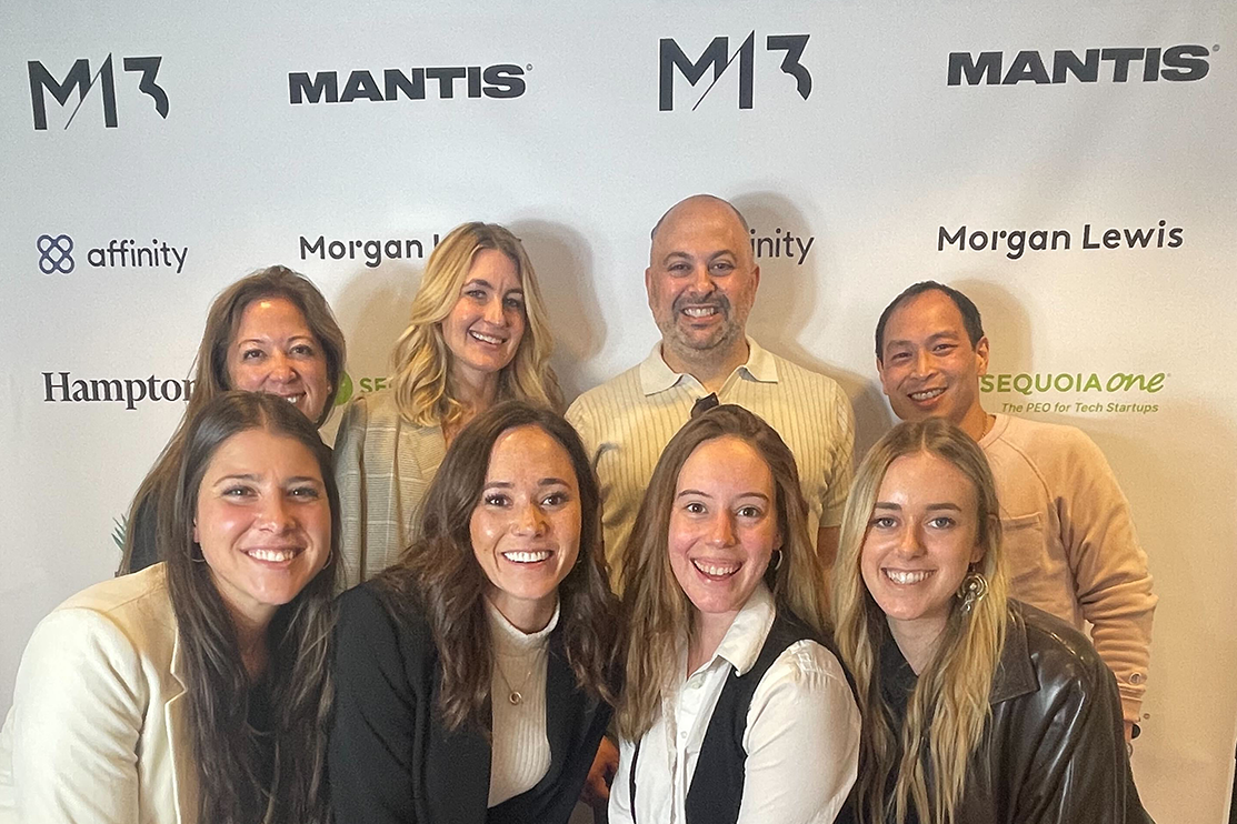 M13 Propulsion team standing in front of a branded backdrop at the M13 x Mantis closeout event at LA Tech Week