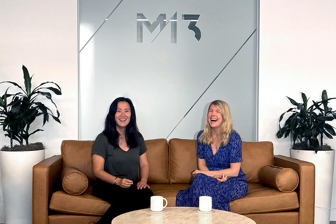 WeeCare CEO Jessica Chang with M13 Partner Anna Barber sitting on a couch at the M13 LA office