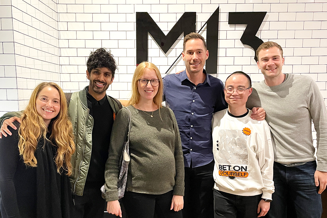 Pietra founding team standing in front of the M13 sign at the M13 office with M13 Partner & Co-founder Carter Reum, Partner Brent Murri, and investor Morgan Blumberg