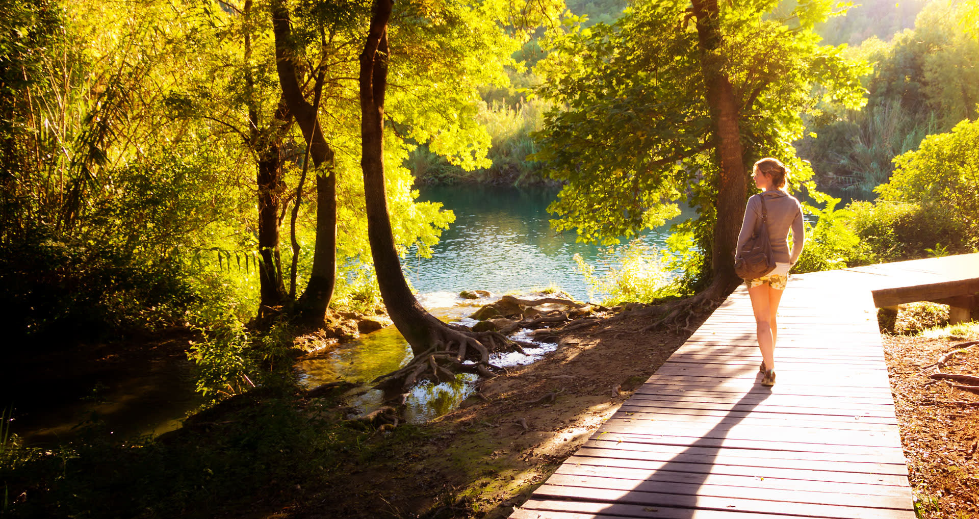 woman-walking-on-a-shaded-walkway-i-screen