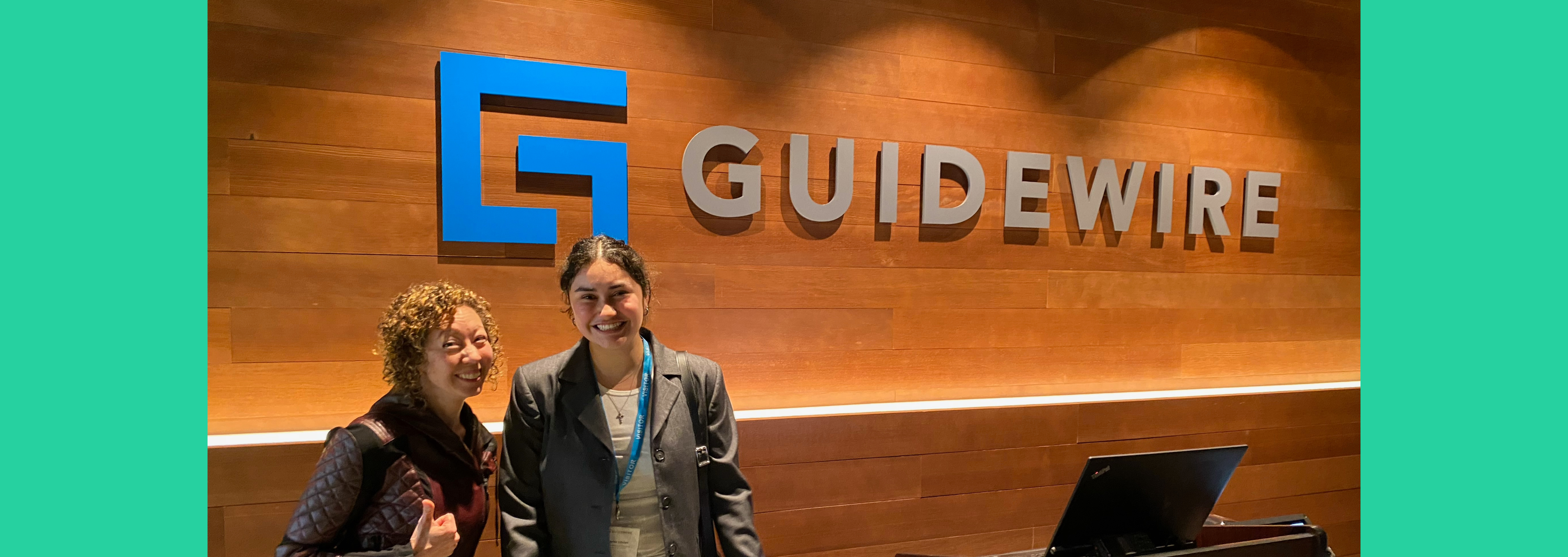 Kaylee and Grace in front of Guidewire logo - San Mateo Office