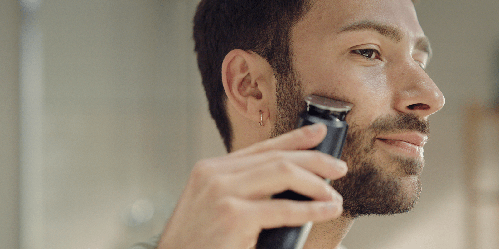 shaving hair with beard trimmer