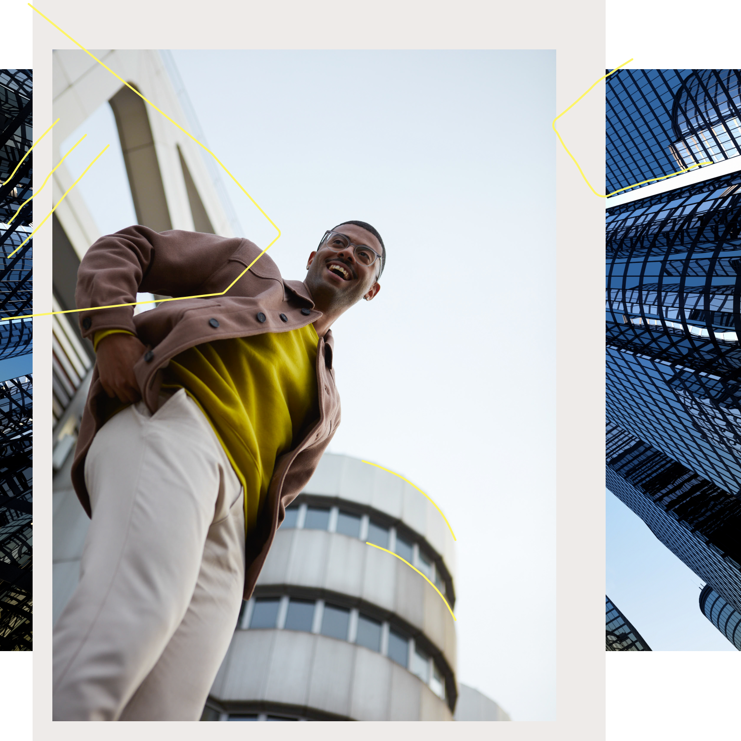 Man with yellow sweater stands in front of a building