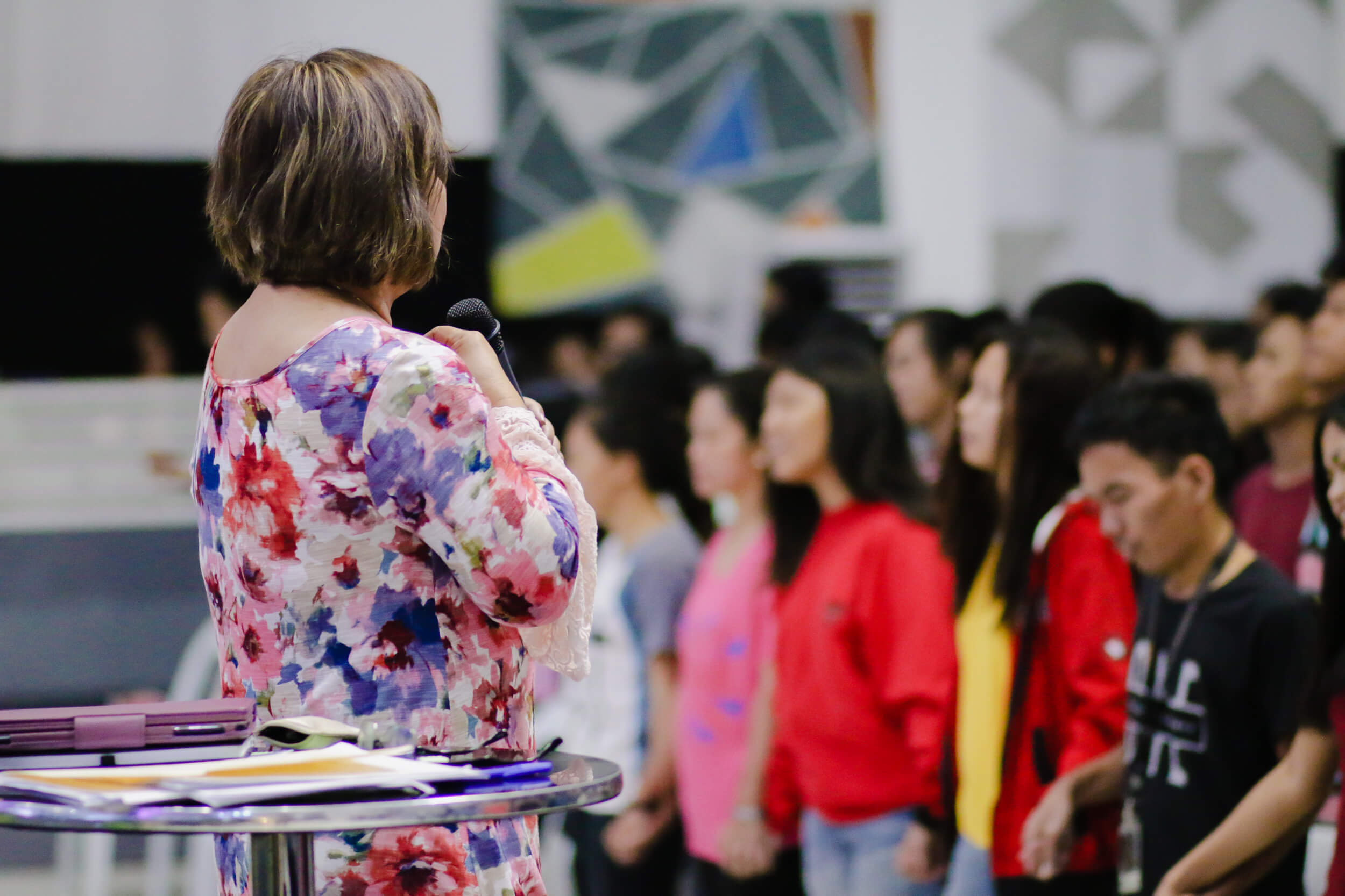 Cristina Sosso praying in front of the crowd at CCFI-Gensan in General Santos City