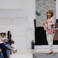 Pastor Cristina Sosso speaking on an elevated platform at CCFI-Gensan in General Santos City.