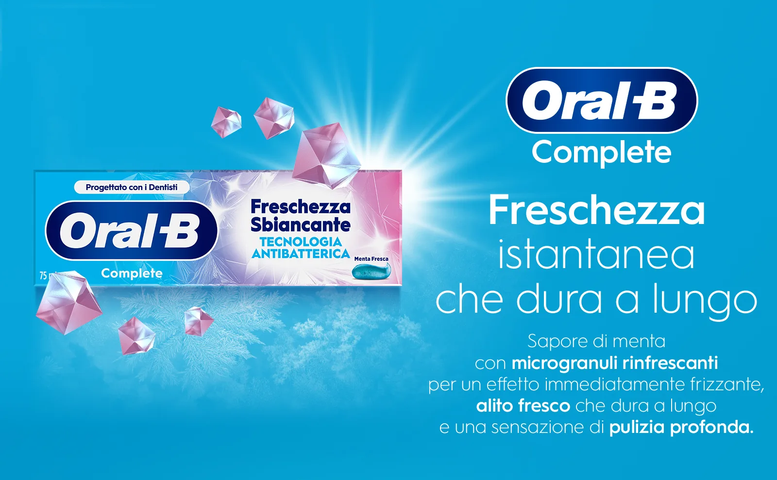 Scatola del dentifricio circondata da fiocchi di neve e diamanti														 