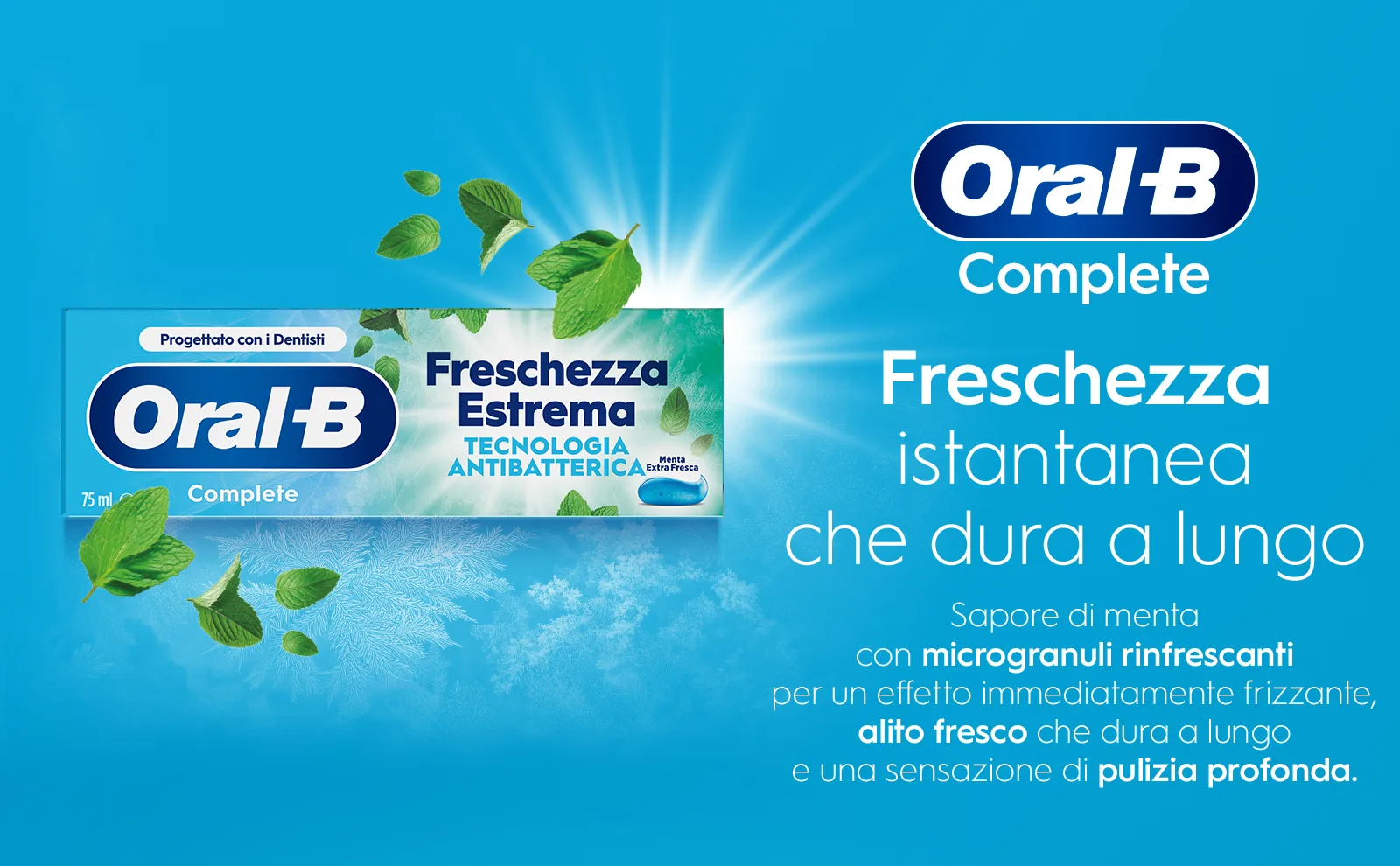 Scatola del dentifricio circondata da fiocchi di neve e foglie di menta 