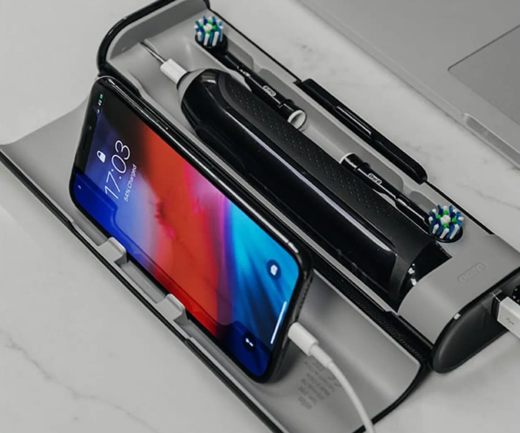 Black Oral-B Genius X electric toothbrush in its charging case 