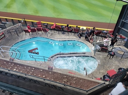 Overhead picture of Chase Field’s pool and hot tub surrounded by chairs and people watching the game.