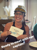 Female group travel leader showing a handwritten sign and wearing a cruise 