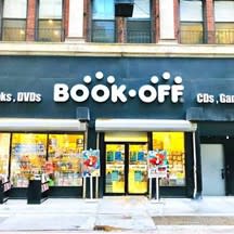 Image of the BookOff bookstore with colorful displays in the windows and a large white BOOK OFF sign on a dark blue background.