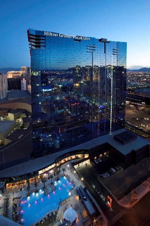 The mirrored surface of Elara, a Hilton Grand Vacations Club tower reflects the city at night.