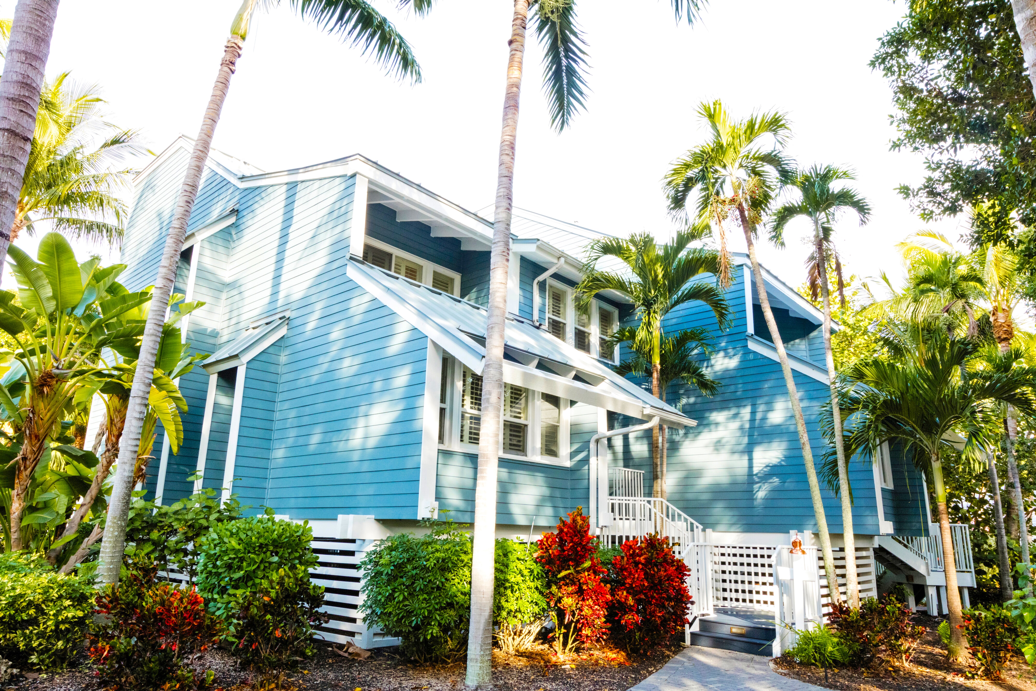 Exterior of accommodations at the South Seas Island Resort with lush landscaping and palm trees
