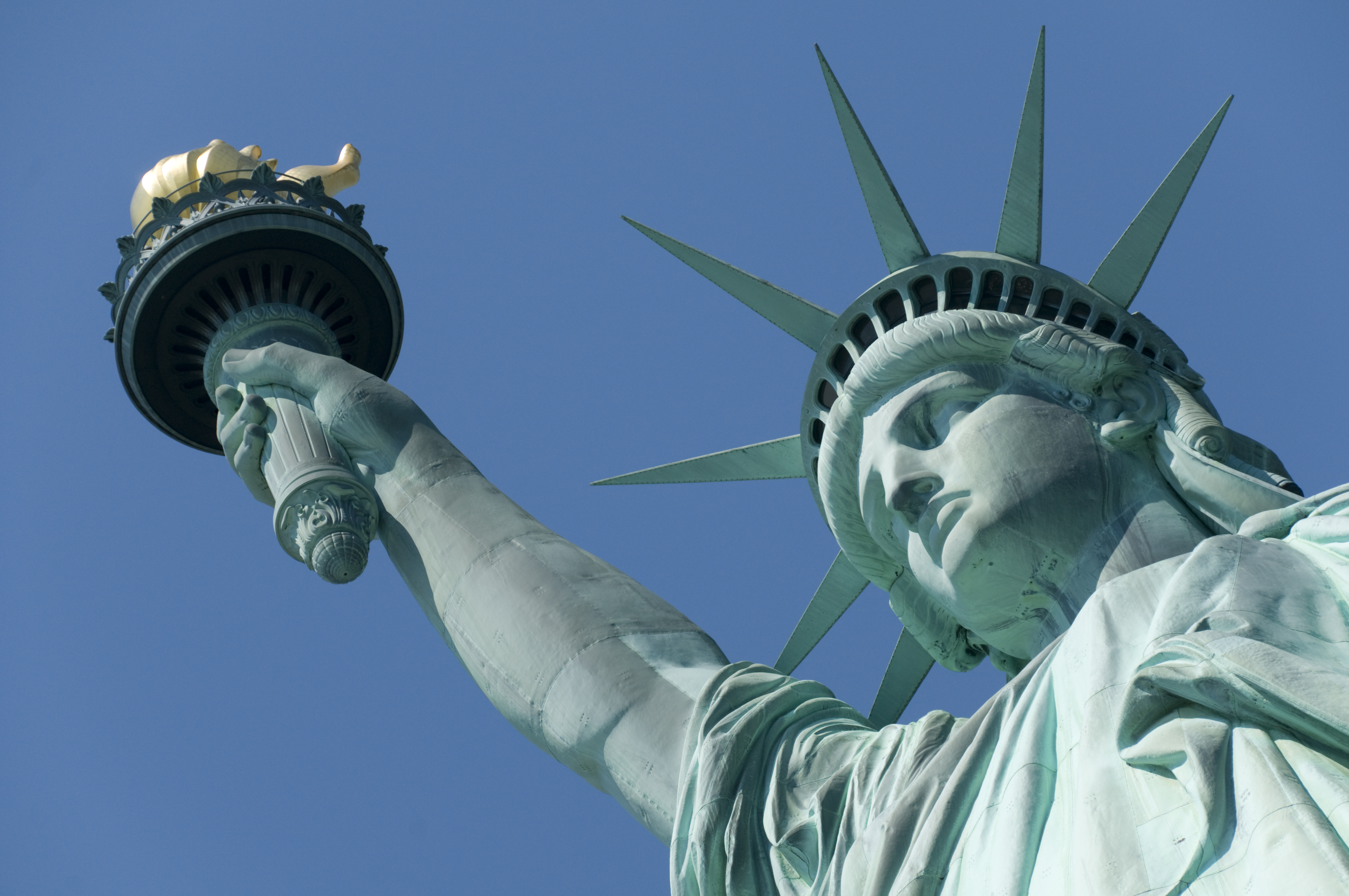 Close-up of the Statue of Liberty with a clear, blue sky above